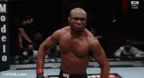 A Shirtless Fighter Stands In Front Of A Banner That Says Ufc Live GIF