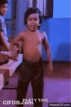 A Shirtless Little Boy Is Dancing In A Room With A Blue Background . GIF