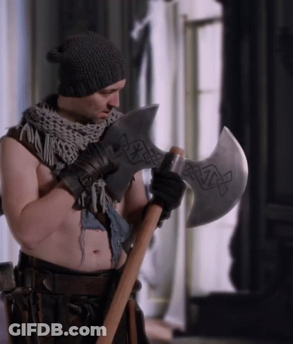 A Shirtless Man Holding A Large Axe With A Celtic Design On It GIF