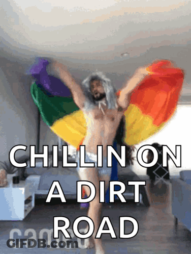 A Shirtless Man Holding A Rainbow Flag With The Words Chillin On A Dirt Road Above Him GIF