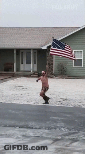 A Shirtless Man Holding An American Flag In Front Of A House GIF