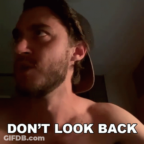 A Shirtless Man In A Baseball Cap Says " Don T Look Back " GIF