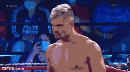 A Shirtless Man In A Boxing Ring With # 205Live On The Bottom Left GIF