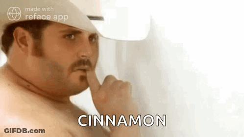 A Shirtless Man In A Cowboy Hat Is Holding His Finger To His Mouth And Saying `` Cinnamon '' . GIF