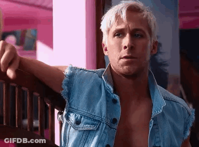 A Shirtless Man In A Denim Vest Is Leaning On A Wooden Railing . GIF