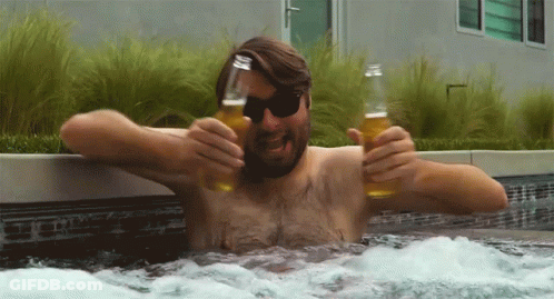 A Shirtless Man In A Hot Tub Holds Two Bottles Of Beer GIF