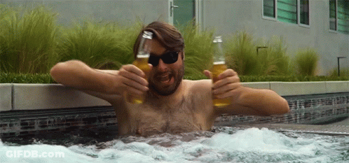 A Shirtless Man In A Hot Tub Is Holding Two Bottles Of Beer GIF