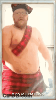 A Shirtless Man In A Kilt With The Words Kiss Me I 'M Irish GIF