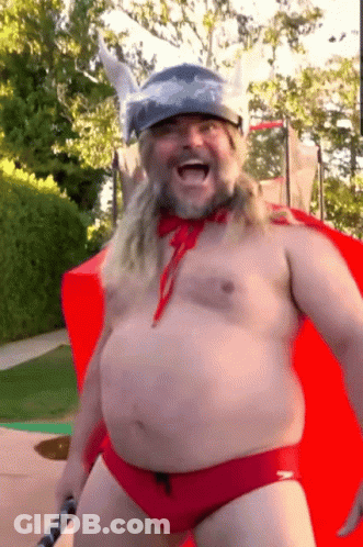 A Shirtless Man In A Red Speedo And A Viking Helmet GIF