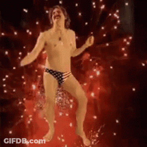 A Shirtless Man In American Flag Underwear Is Dancing On A Red Floor . GIF