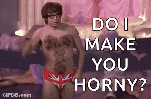 A Shirtless Man In British Flag Underwear Is Standing In Front Of A Bed And Asking Do I Make You Horny ? GIF
