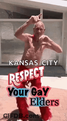 A Shirtless Man In Red Pants Is Dancing In Front Of A Building With The Words Kansas City Respect Your Gay Elders . GIF
