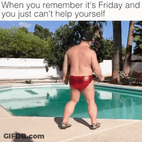 A Shirtless Man In Red Swim Trunks Is Standing In Front Of A Pool . GIF