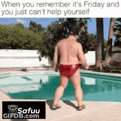 A Shirtless Man In Red Swim Trunks Is Standing Next To A Pool . GIF