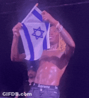 A Shirtless Man In Supreme Underwear Holds A Flag GIF