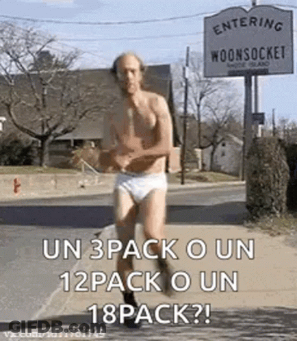 A Shirtless Man In Underwear Is Running Down A Street In Front Of A Sign That Says Entering Woonsocket . GIF