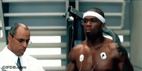 A Shirtless Man Is Being Examined By A Doctor While Wearing A Headband . GIF
