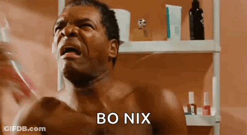 A Shirtless Man Is Brushing His Teeth In Front Of A Bathroom Mirror While Crying . GIF