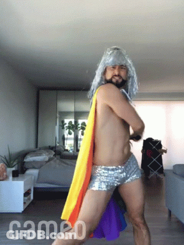 A Shirtless Man Is Dancing In A Room With The Word Cameo On The Floor GIF