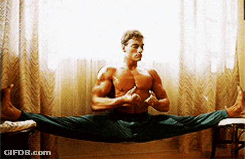 A Shirtless Man Is Doing A Split In Front Of A Window . GIF