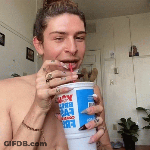 A Shirtless Man Is Drinking From A Cup That Says Eve2 GIF
