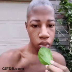 Shirtless Man Eating Green Leaf GIF