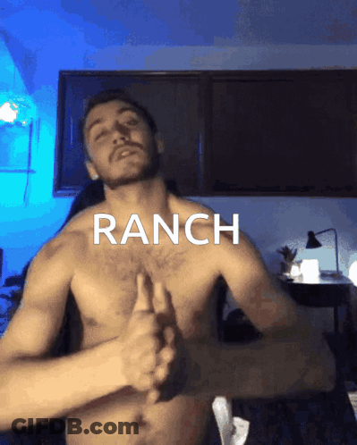 A Shirtless Man Is Giving A Thumbs Up In Front Of A Sign That Says Ranch GIF