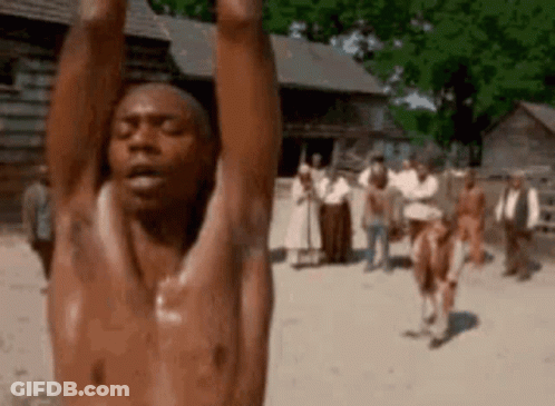 A Shirtless Man Is Hanging Upside Down With His Arms In The Air . GIF