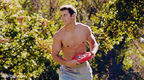 A Shirtless Man Is Holding A Frisbee In His Hand GIF