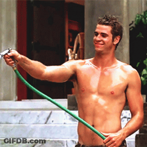 A Shirtless Man Is Holding A Hose And Smiling GIF