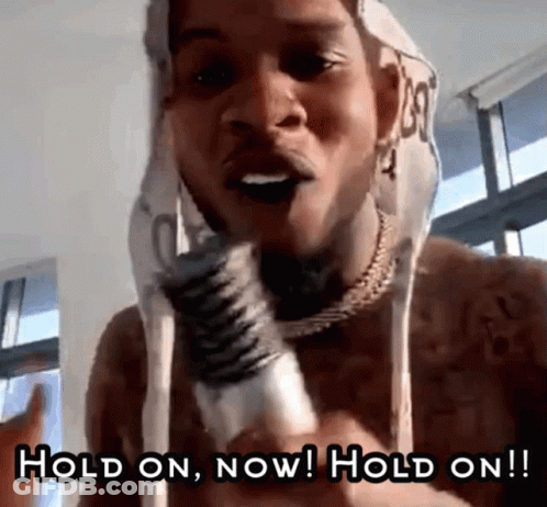 A Shirtless Man Is Holding A Microphone And Says Hold On Now Hold On !! GIF
