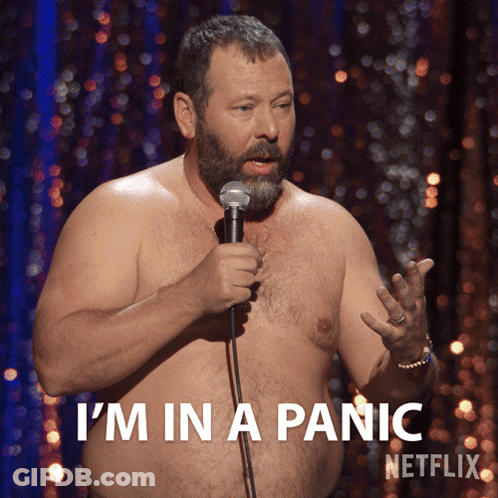 A Shirtless Man Is Holding A Microphone And Says I 'M In A Panic Netflix GIF