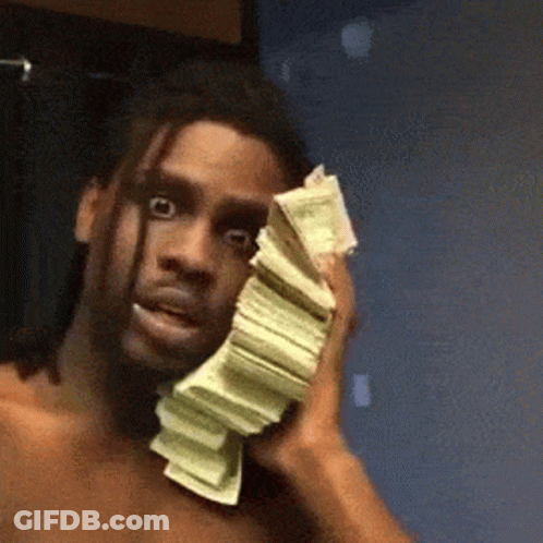 A Shirtless Man Is Holding A Stack Of Money Over His Face . GIF