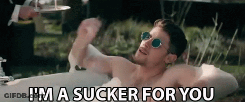 A Shirtless Man Is Laying In A Bathtub And Saying I 'M A Sucker For You . GIF