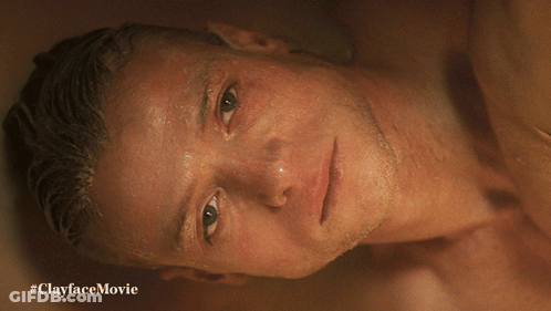 A Shirtless Man Is Laying In A Bathtub With #Clayfacemovie Written On The Bottom GIF
