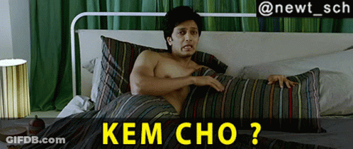 A Shirtless Man Is Laying On A Bed With A Striped Comforter And The Caption Kem Cho GIF