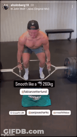 A Shirtless Man Is Lifting A Barbell In A Gym GIF