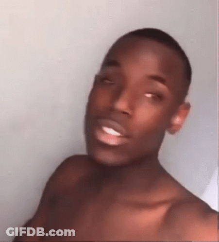 A Shirtless Man Is Making A Funny Face While Taking A Selfie . GIF