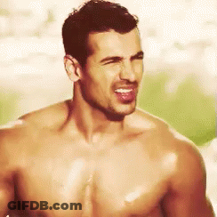 A Shirtless Man Is Making A Funny Face With His Tongue Sticking Out . GIF