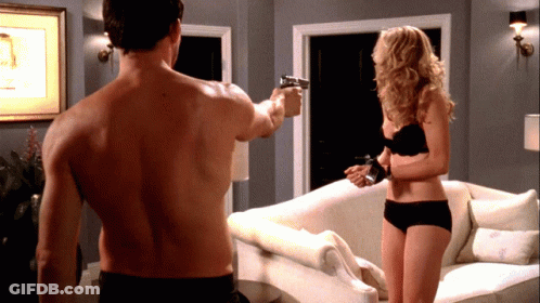 A Shirtless Man Is Pointing A Gun At A Woman In Black Underwear GIF