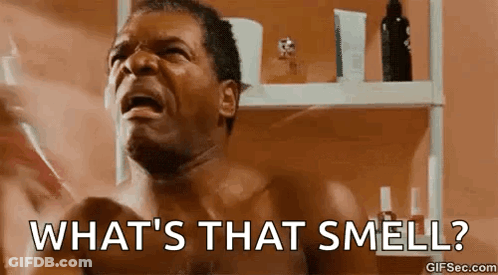 A Shirtless Man Is Screaming In Front Of A Bathroom Mirror And Asking What 'S That Smell . GIF