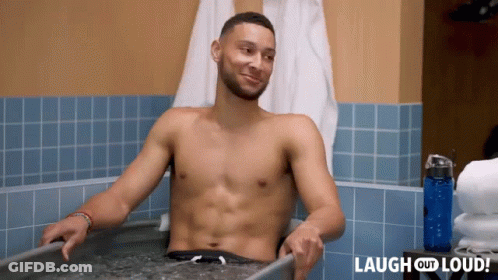 A Shirtless Man Is Sitting In A Bathtub With The Words Laugh Out Loud Behind Him GIF
