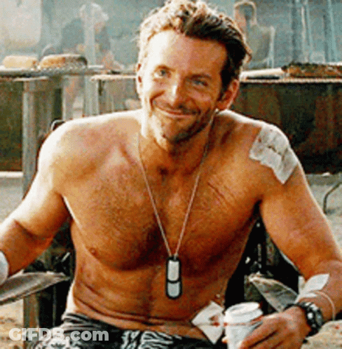A Shirtless Man Is Sitting In A Chair Holding A Can Of Beer GIF