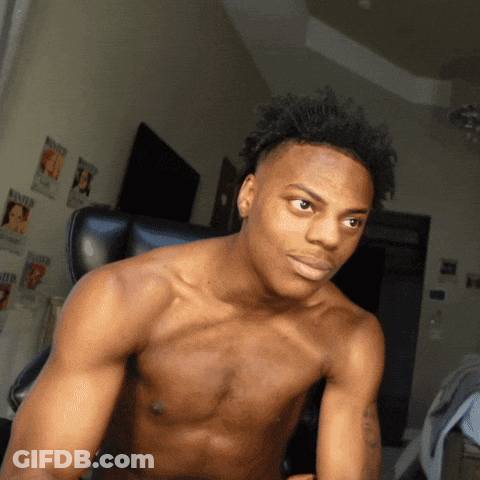 A Shirtless Man Is Sitting In A Chair In Front Of A Wall With Wanted Posters On It GIF