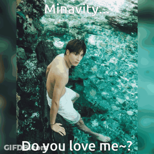 A Shirtless Man Is Sitting On A Rock In The Water With The Words Minavity Do You Love Me GIF