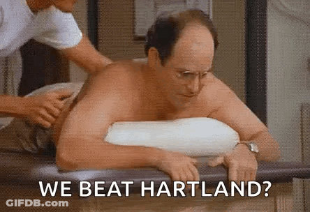 A Shirtless Man Is Sitting On A Table Getting A Massage From A Nurse . GIF