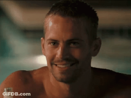 A Shirtless Man Is Smiling And Holding A Bottle Of Beer GIF