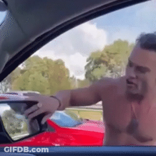 A Shirtless Man Is Standing In A Car With His Trunk Open . GIF