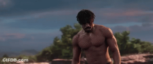 A Shirtless Man Is Standing In A Field With The Words `` Is This Your King ? '' Written On The Screen . GIF