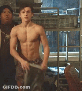 A Shirtless Man Is Standing In Front Of A Bunk Bed In A Bedroom . GIF